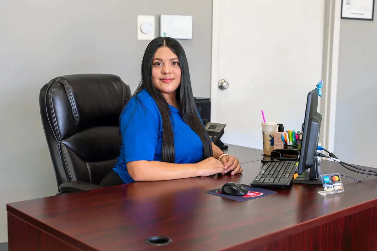 A team member working at her desk with her computer