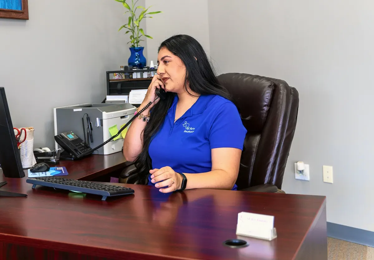 A team member on the phone at her desk