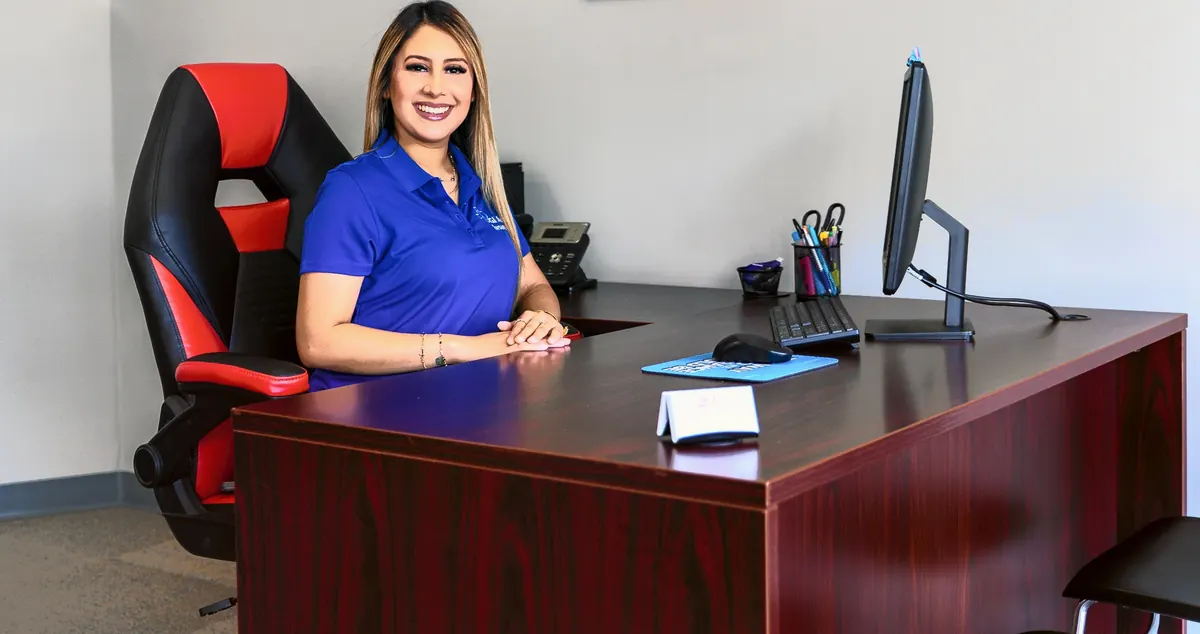 A team member at her desk, ready to help a client