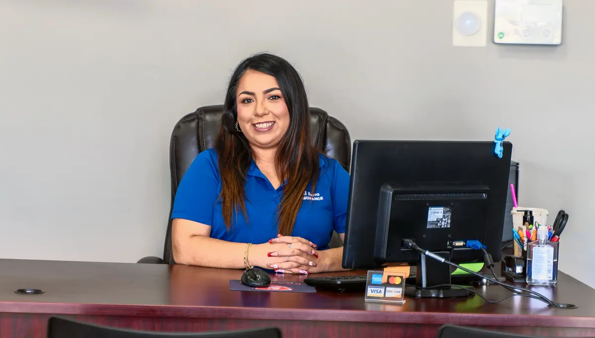 A team member smiling at her desk in the office