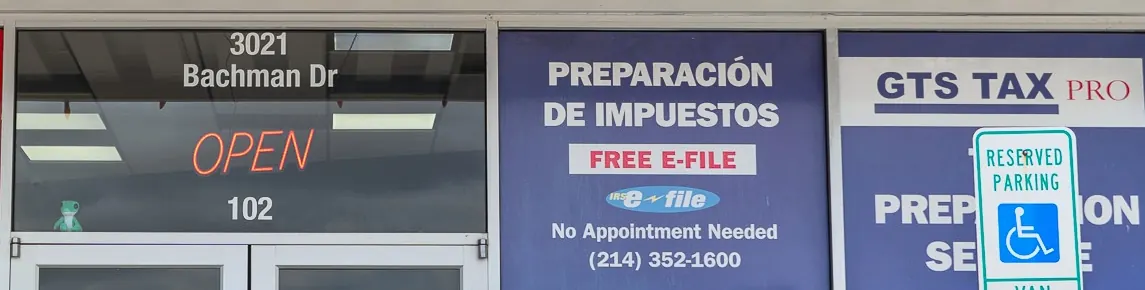 The storefront windows at 3021 Bachman Dr, suite 102: the open sign, Preparación de impuestos with free e-file and no appointment needed, and GTS Tax Pro